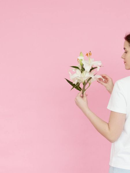 Man in a focused, calm stance against a soft cement colored background.